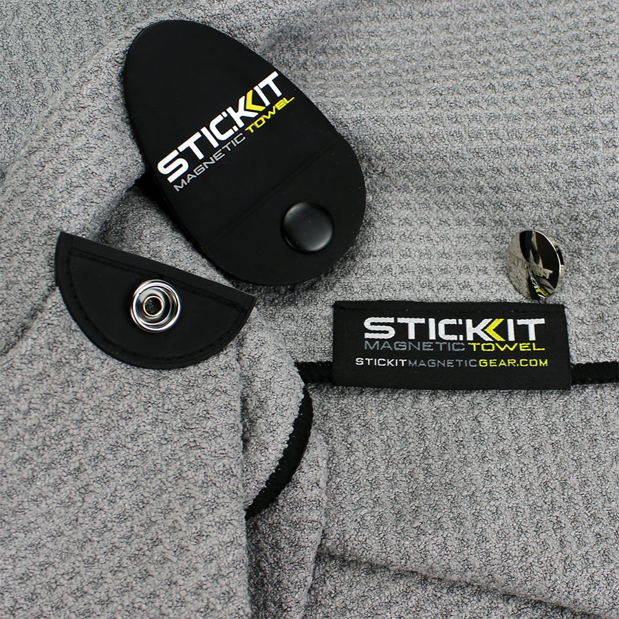 Gray microfiber magnetic towel with black accents and snap closure for easy attachment and storage. Perfect for outdoor use.