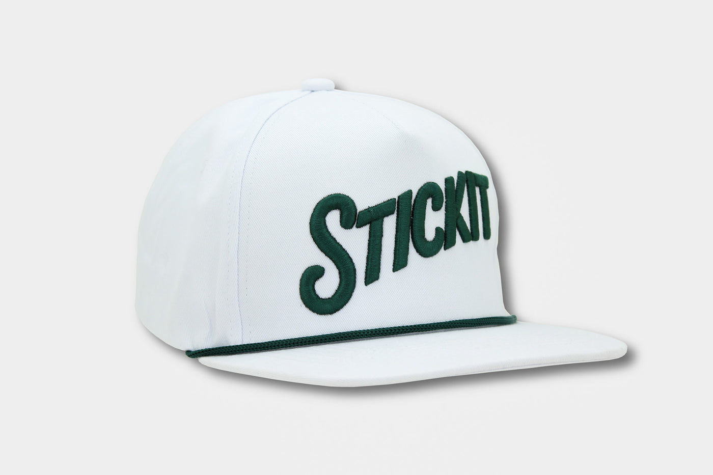 White snapback cap with green "STICKIT" embroidery and green trim. Stylish and casual headwear for everyday wear.