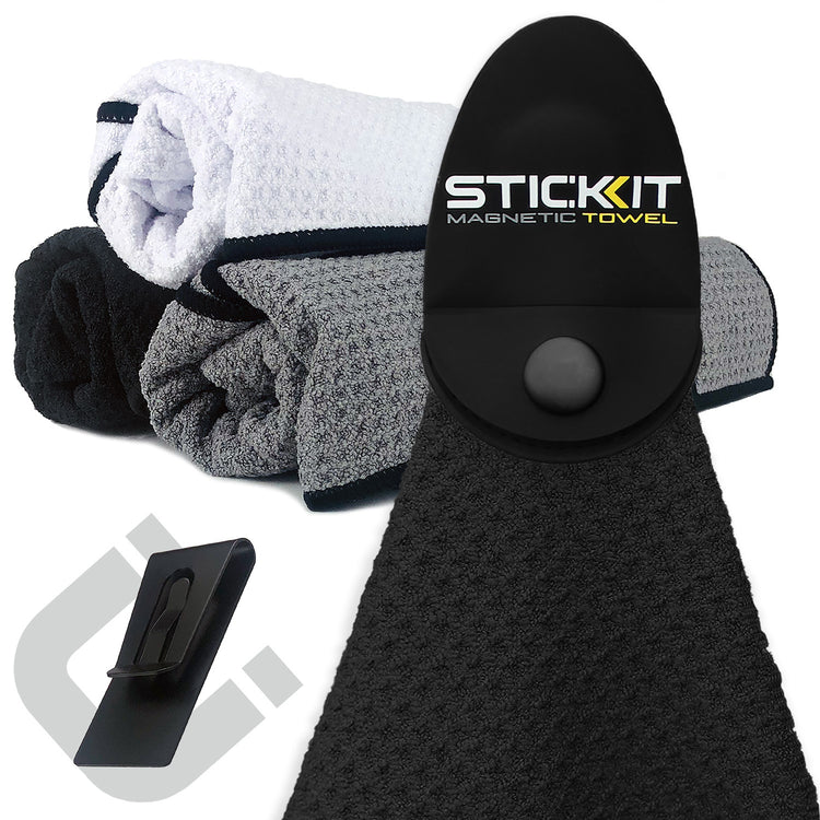 Black magnetic towel with textured fabric, accompanied by gray and white towels, ideal for sports and outdoor activities.